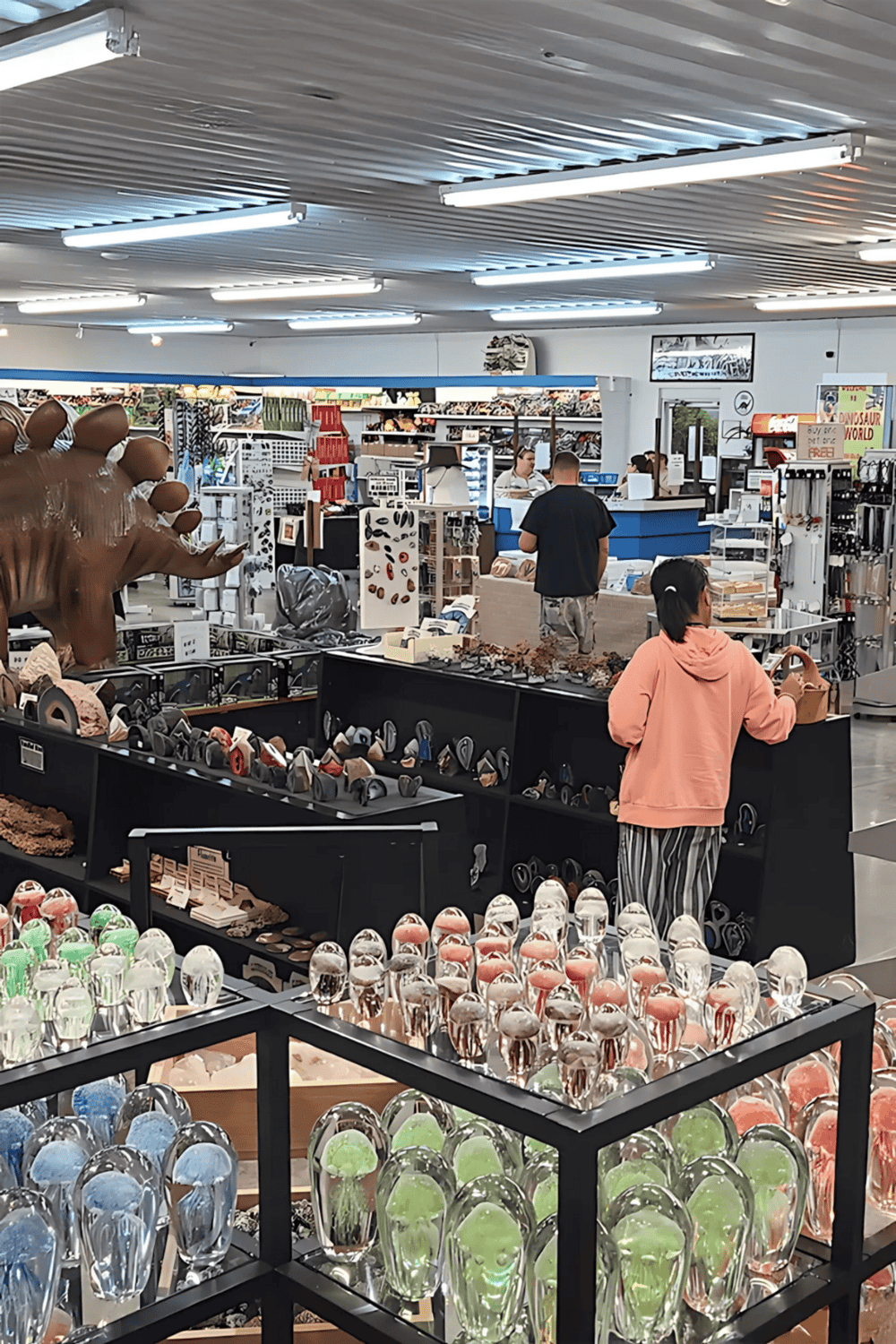 Colorful glass art sculptures in a retail store, showcasing unique home decor and gift items.
