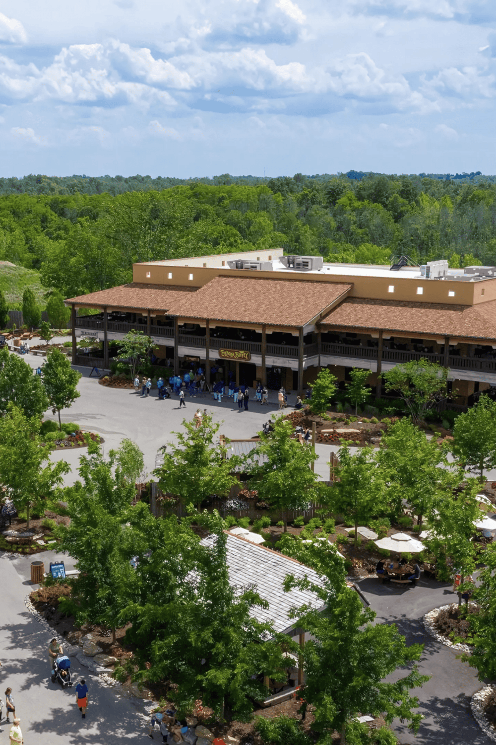 Modern shopping and dining destination with lush greenery and outdoor seating, perfect for family outings and events.