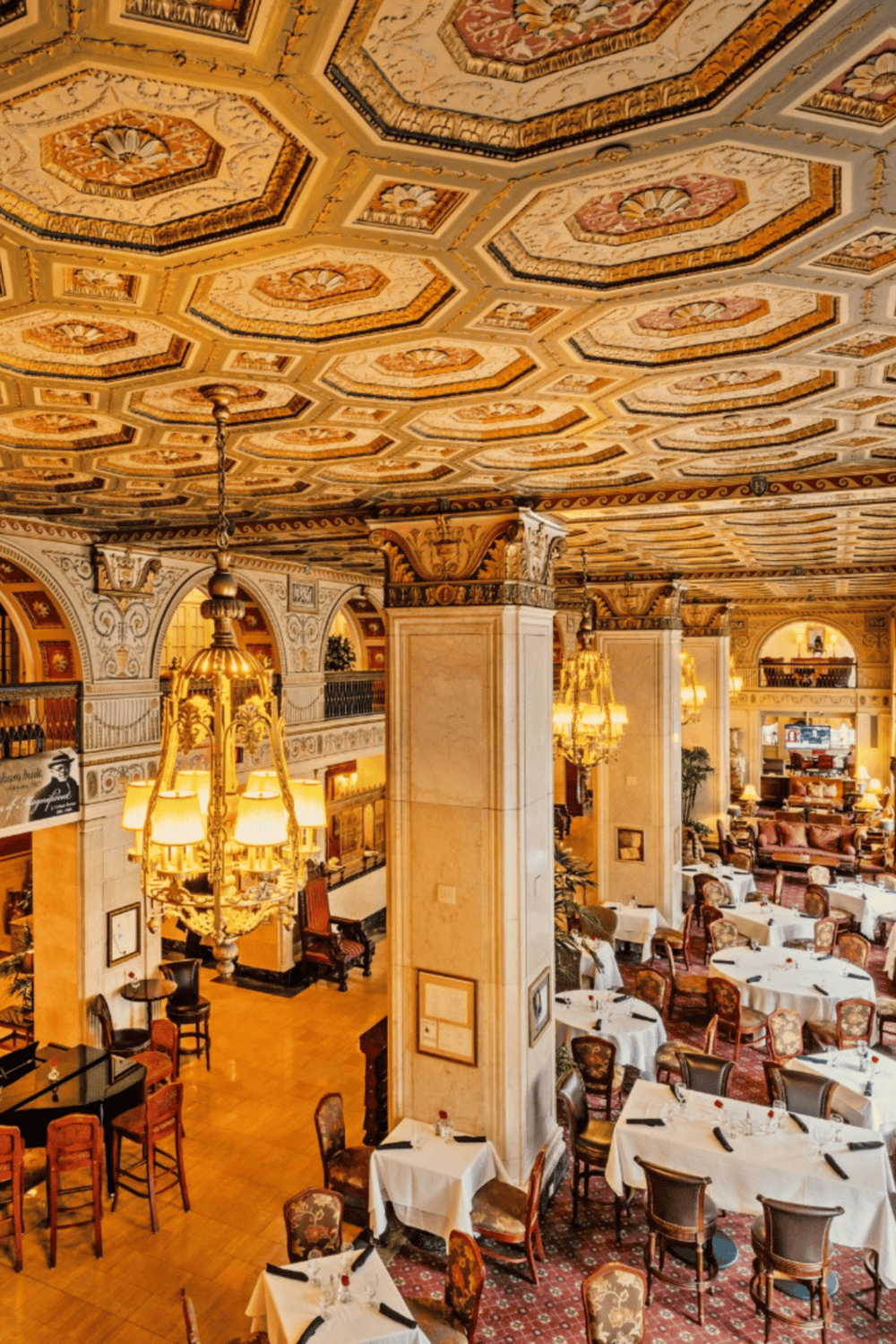 Elegant restaurant interior with ornate ceiling and classic decor emphasizing luxury dining experiences.