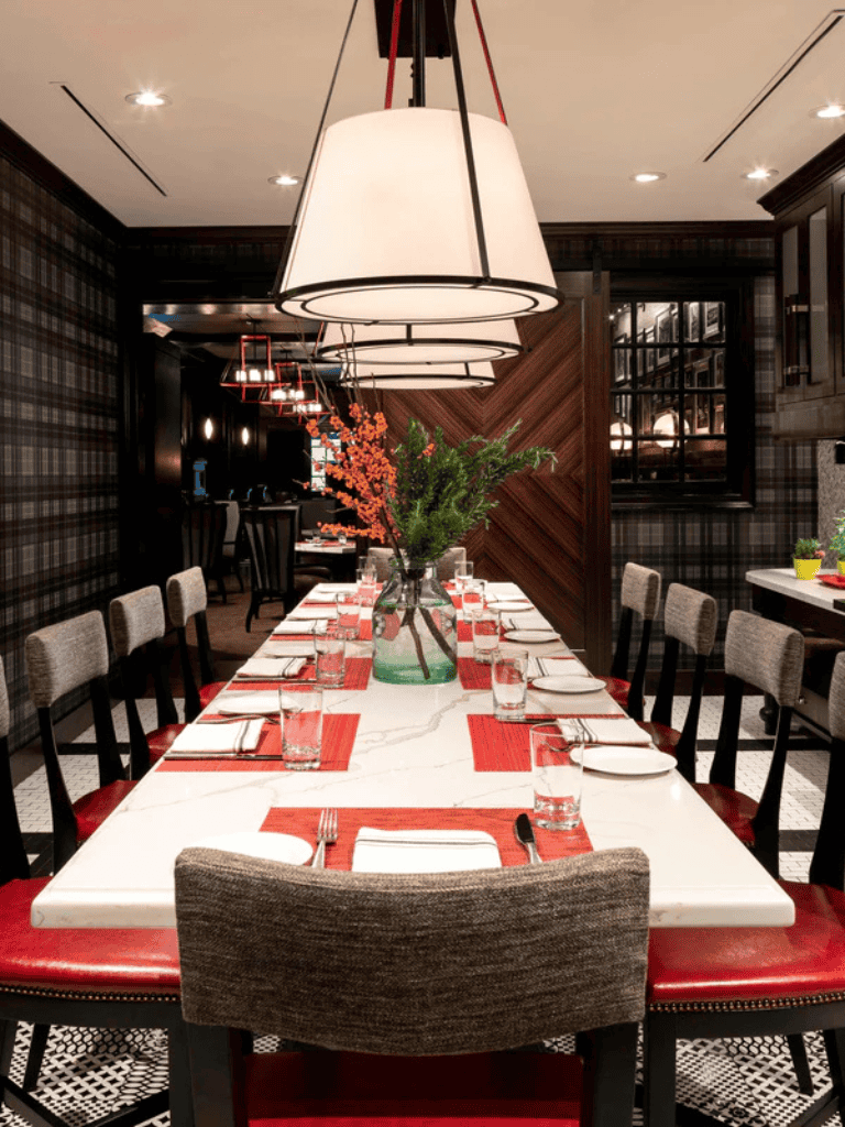 Elegant restaurant dining table with modern decor and floral centerpiece for fine dining experience.