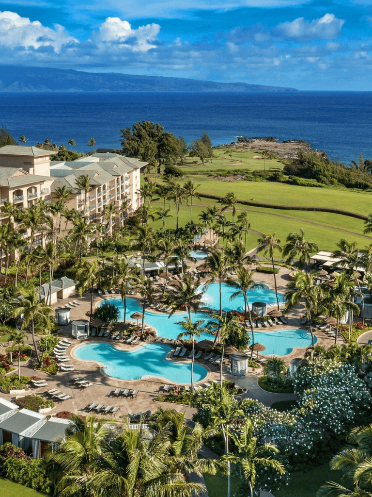 Luxurious oceanfront resort with swimming pools, lush gardens, and scenic views of the Pacific Ocean.