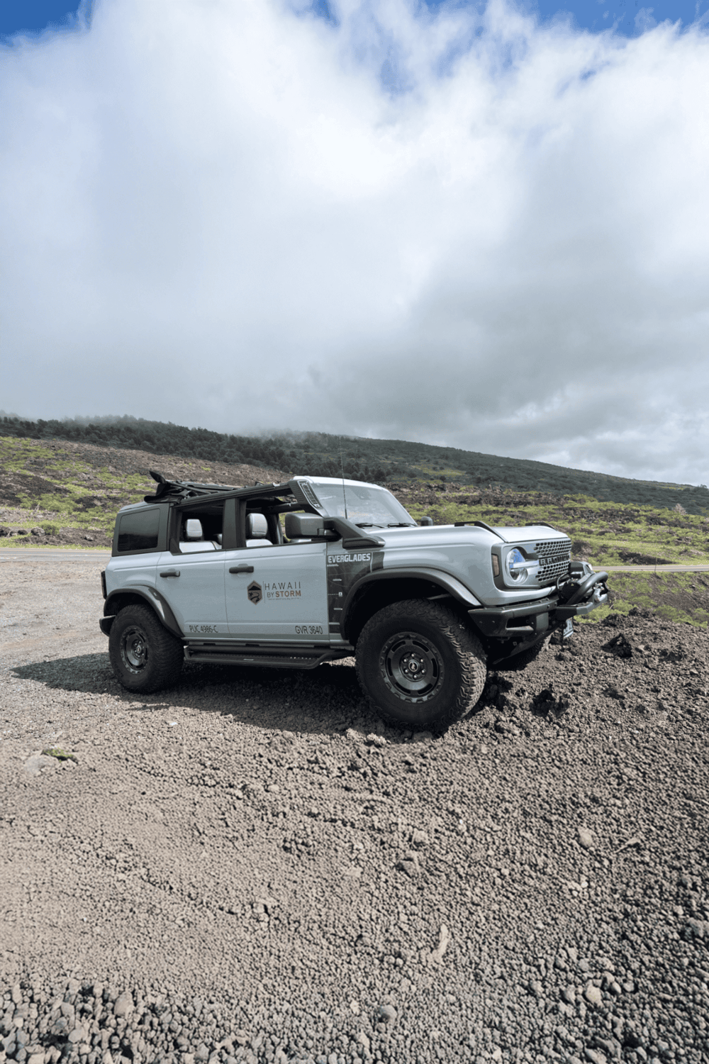 Off-road vehicle exploring volcanic landscape in Hawaii for adventure travel.
