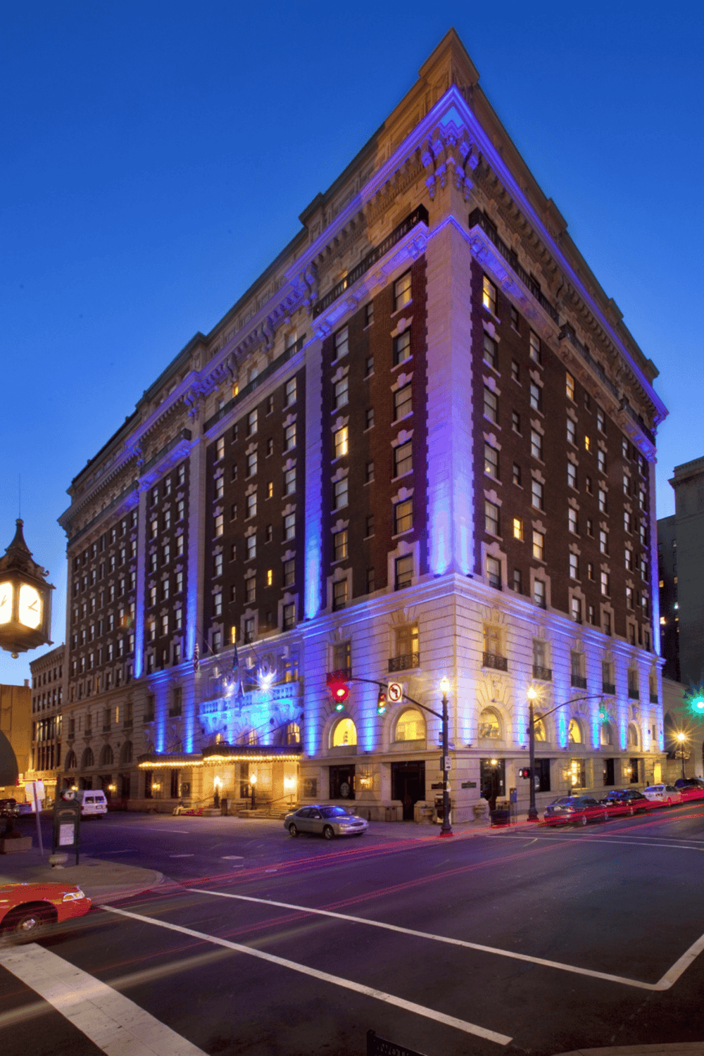 Illuminated historic hotel in downtown with vibrant night lighting, perfect for exploring city landmarks.