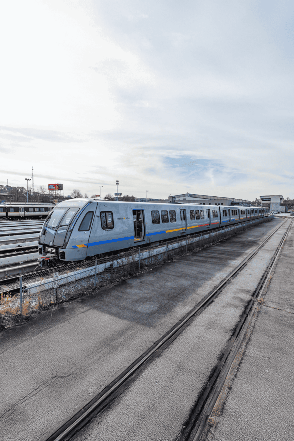 Modern commuter train on outdoor rail yard for public transit transportation.