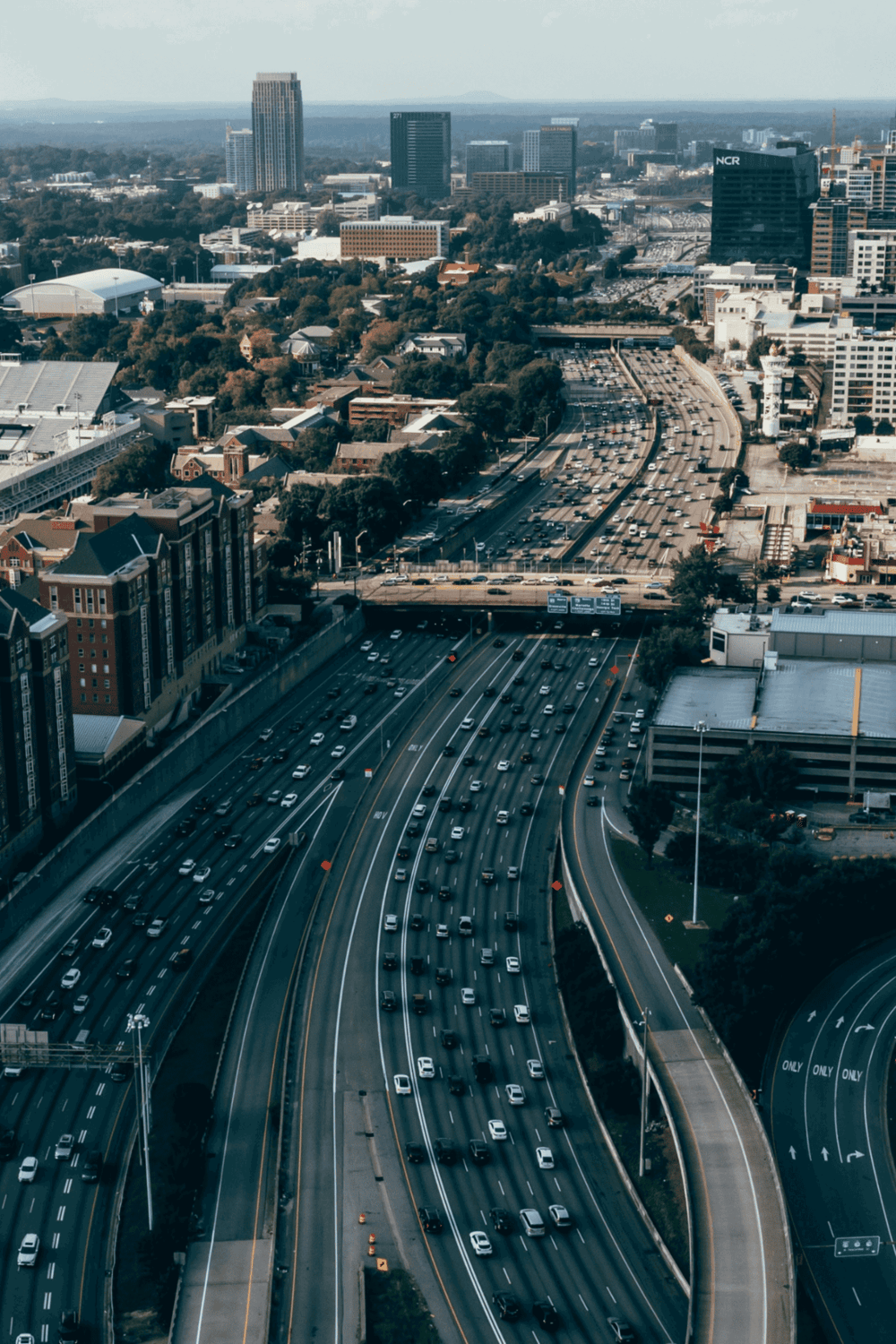Traffic on busy highway in downtown cityscape, urban transportation and travel routes.