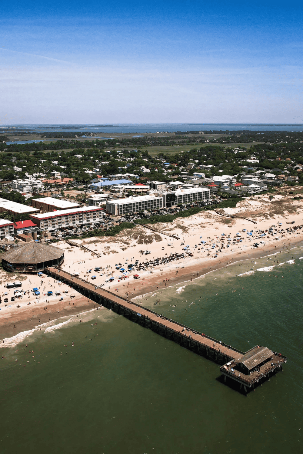 Aerial view of Panama City Beach with pier and beachfront resorts, showcasing popular Gulf Coast destination.