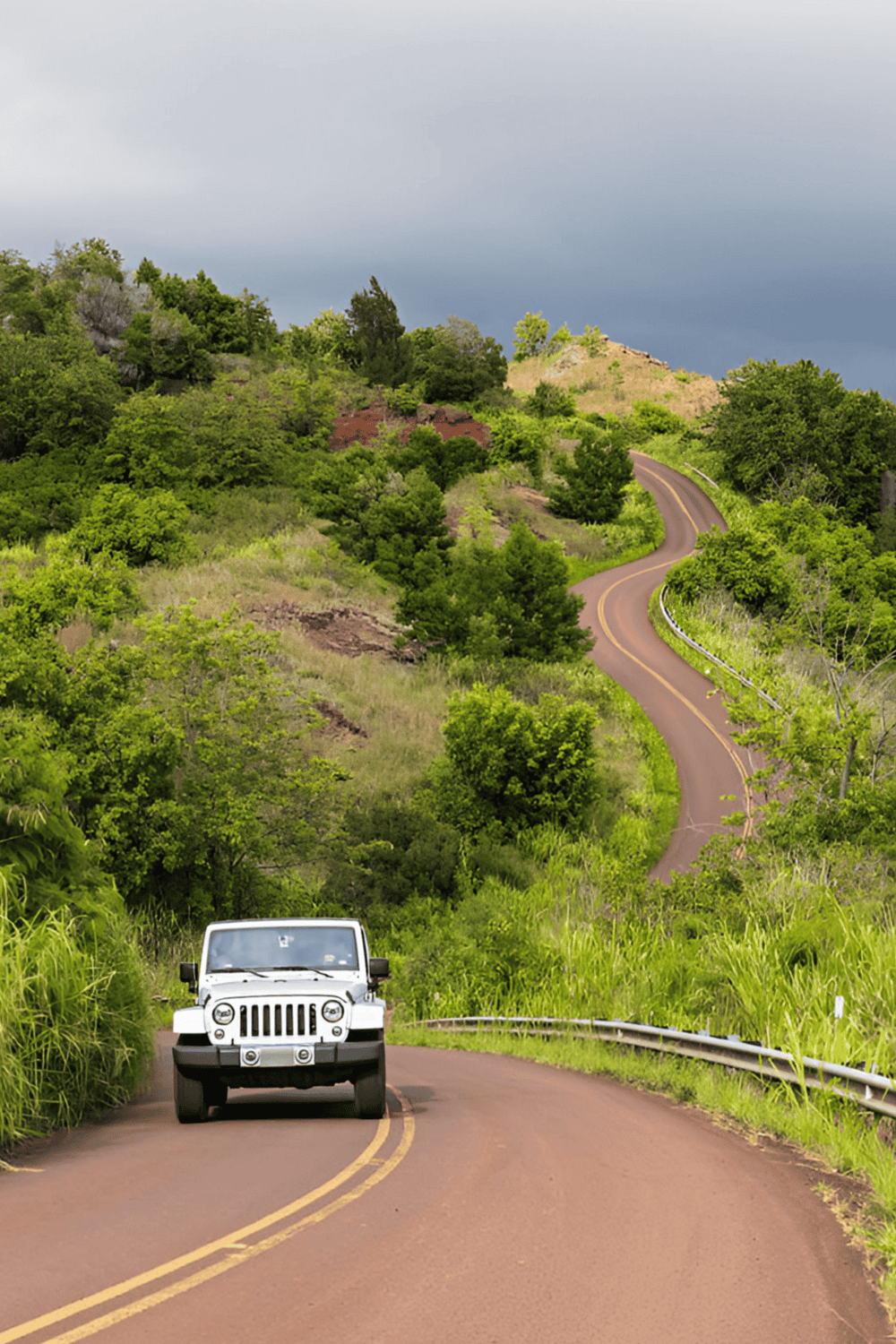 Scenic winding road through lush green hills for travel and navigation inspiration.