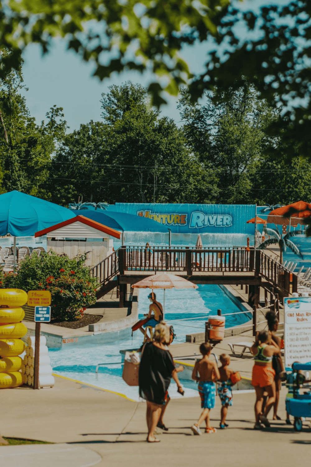 Water park with slides and families enjoying summer fun at Adventure River.