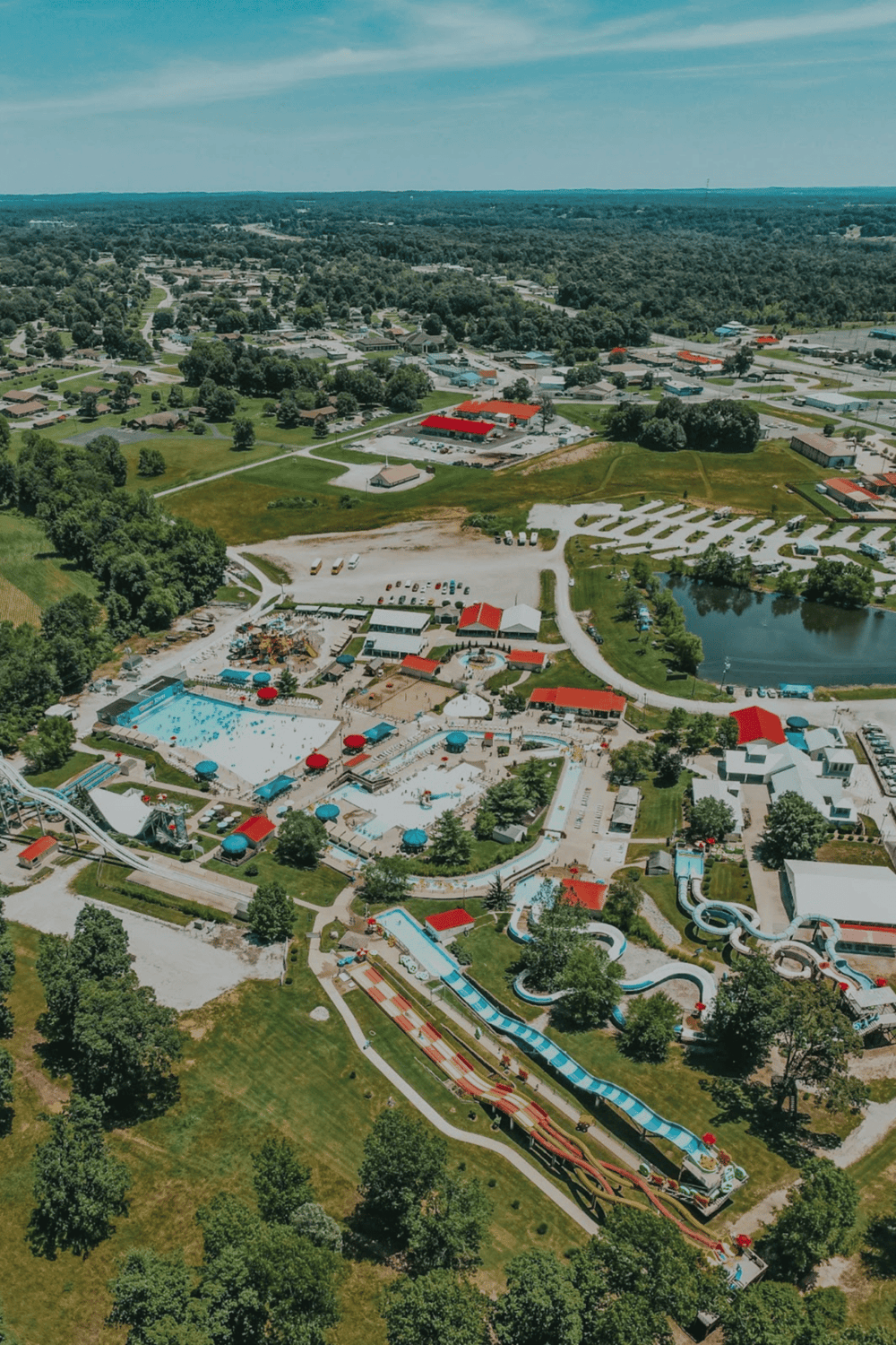 Aerial view of Quest for Directions waterpark with slides, pools, and surrounding town.
