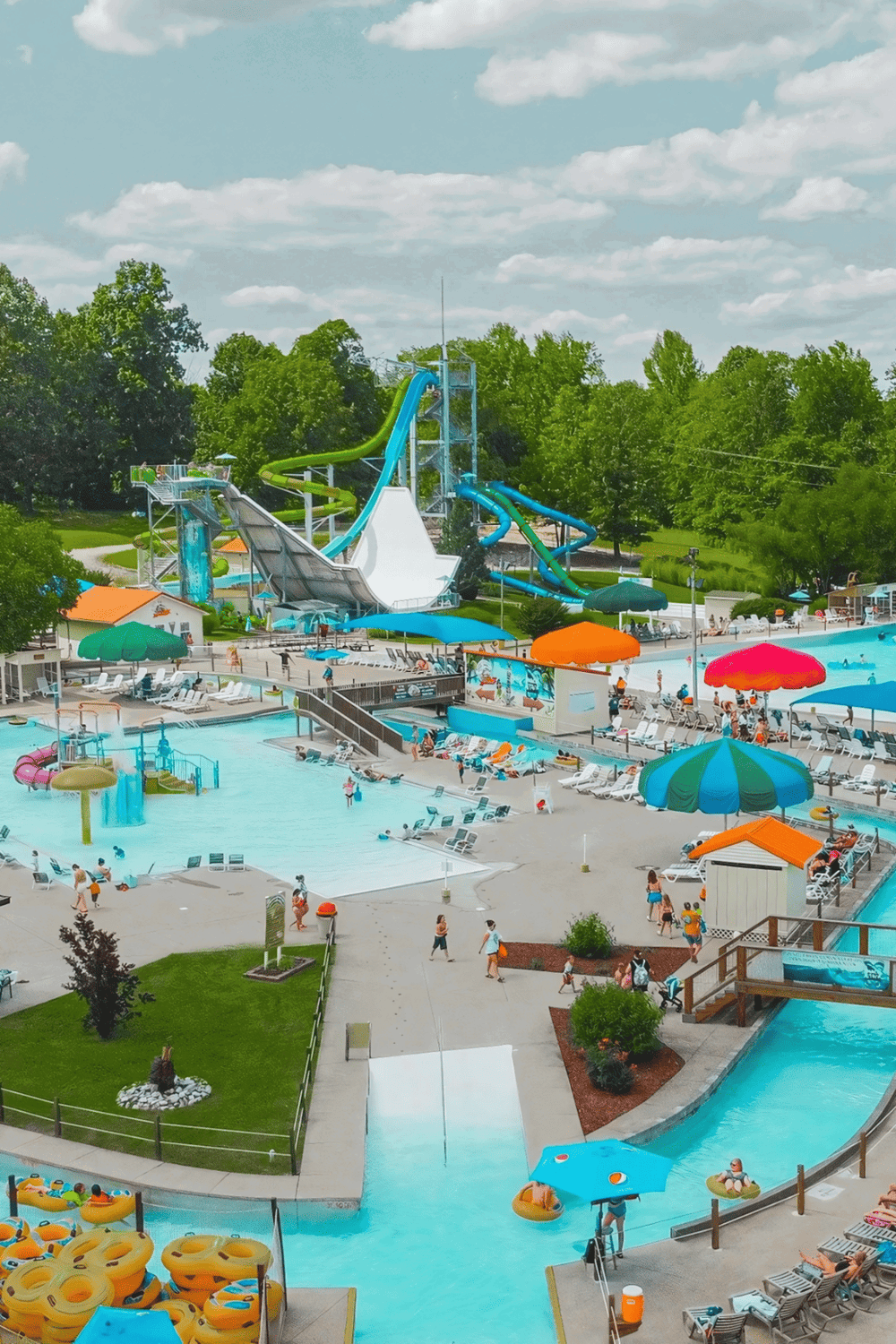 Water park with multiple slides, lazy river, and swimming pools, perfect for family fun and outdoor entertainment.