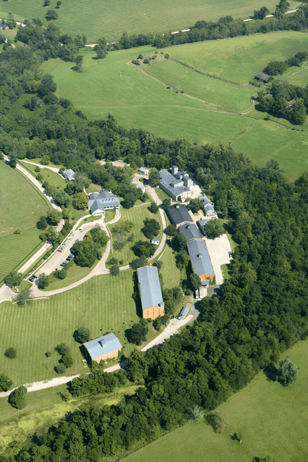 Aerial view of scenic countryside with historic buildings and lush green fields, captured for QuestForDirections.