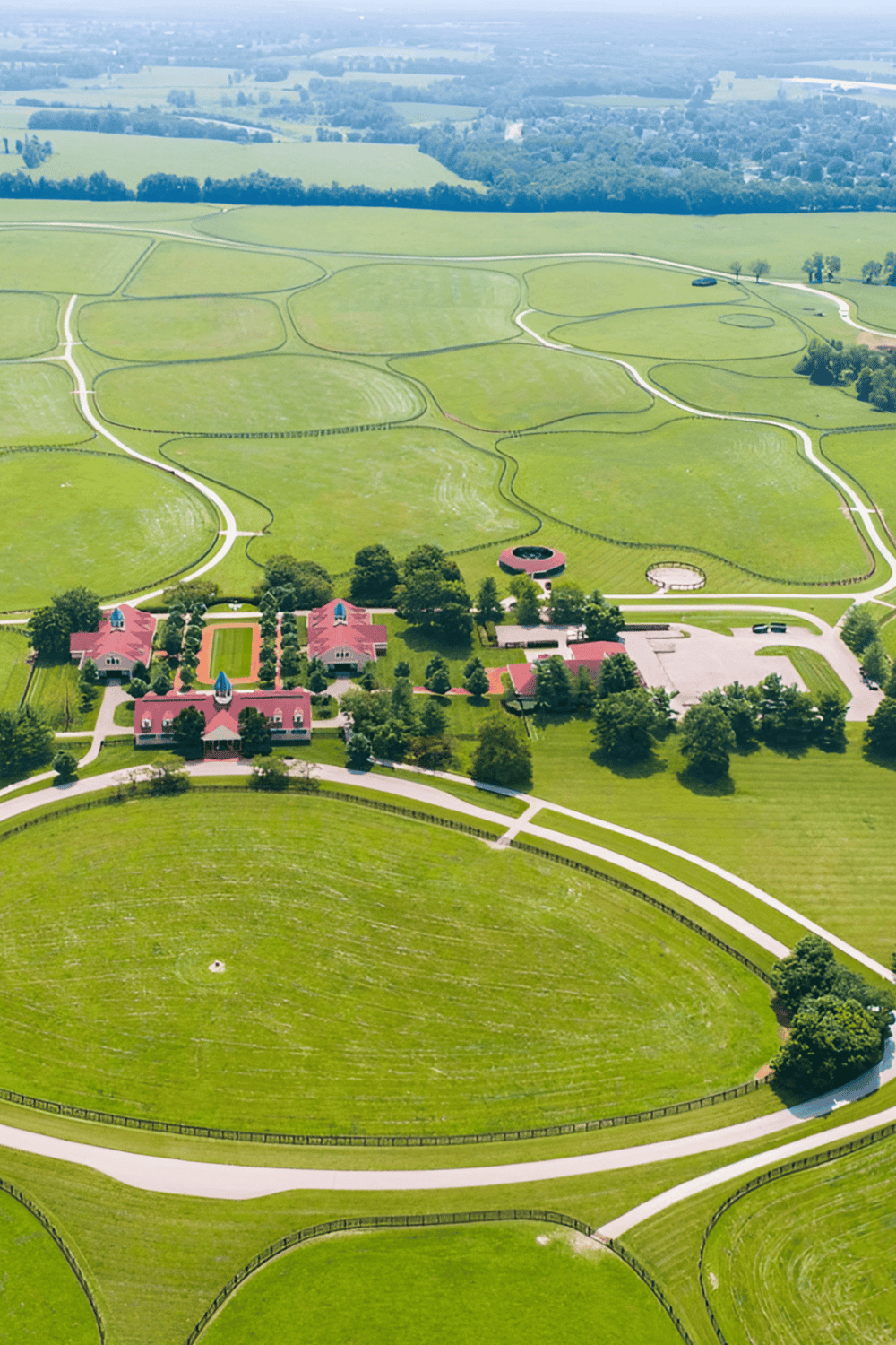 Lush green outdoor education and activity center with scenic walking trails and historical buildings.