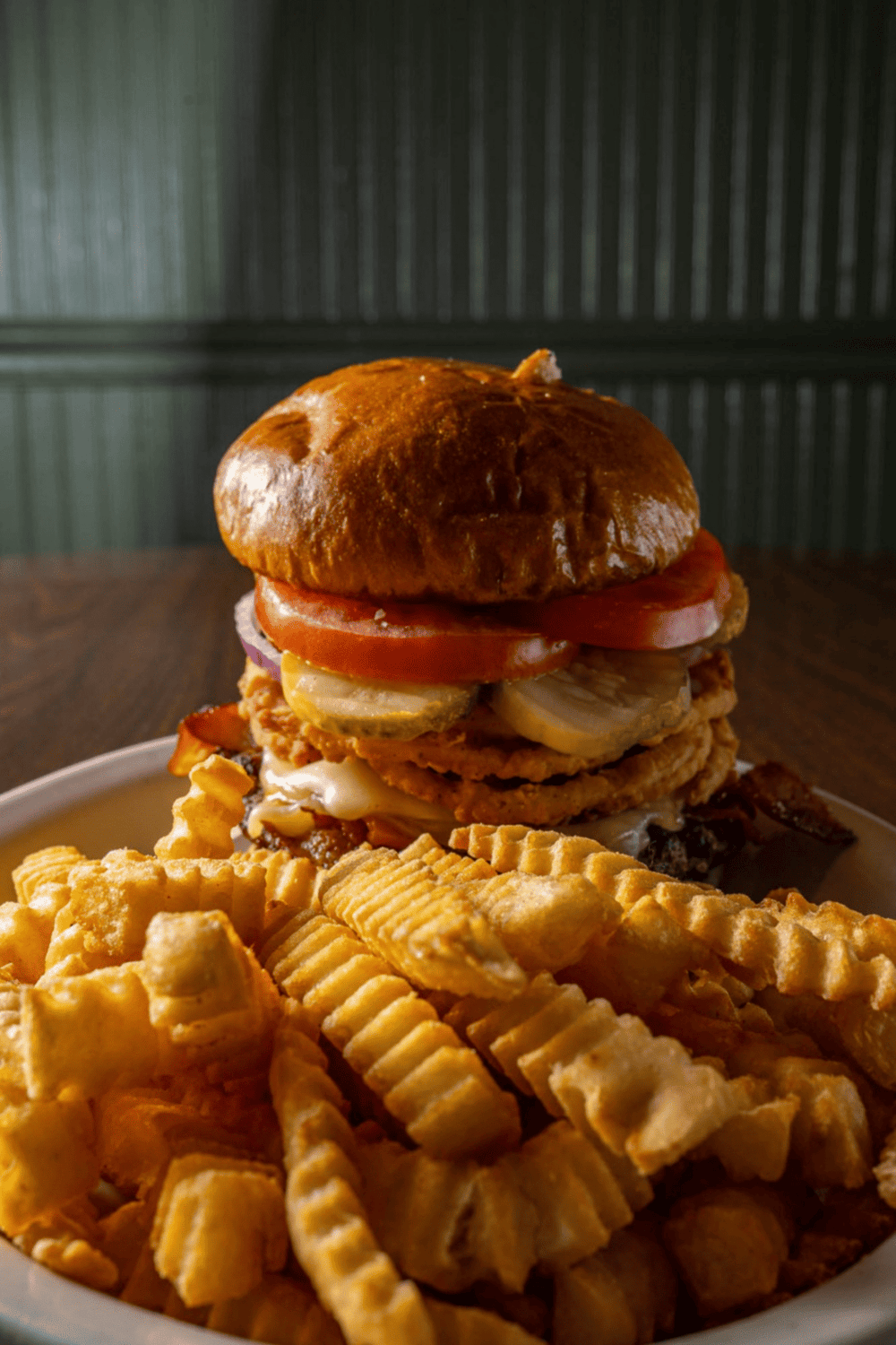 Savory burger with fries on a plate, delicious comfort food meal.