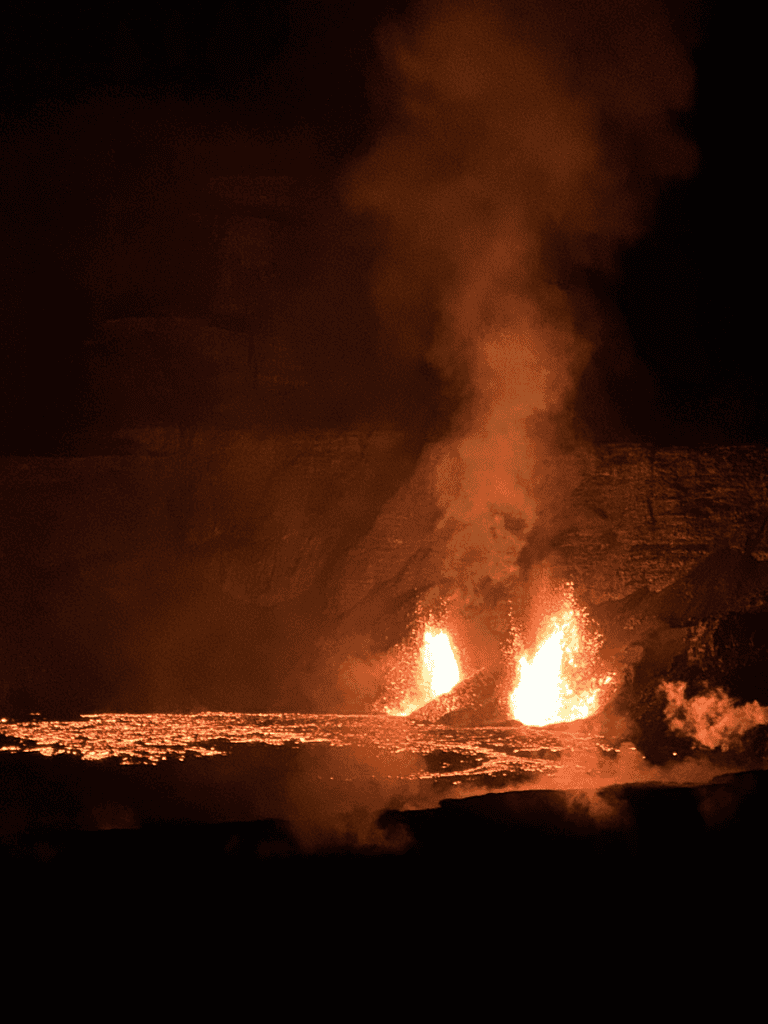 Lava eruption at night creating molten lava flows and volcanic ash plumes in a dramatic volcanic eruption scene.