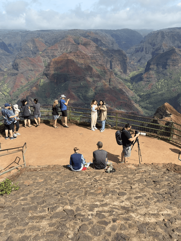 Breathtaking view of the Grand Canyon with visitors taking photos and enjoying the scenery.