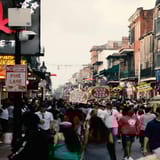 Crowded city street with nightlife, bars, and people enjoying nightlife activities.