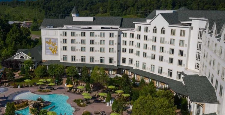 Luxury hotel with outdoor pool and scenic mountain views.