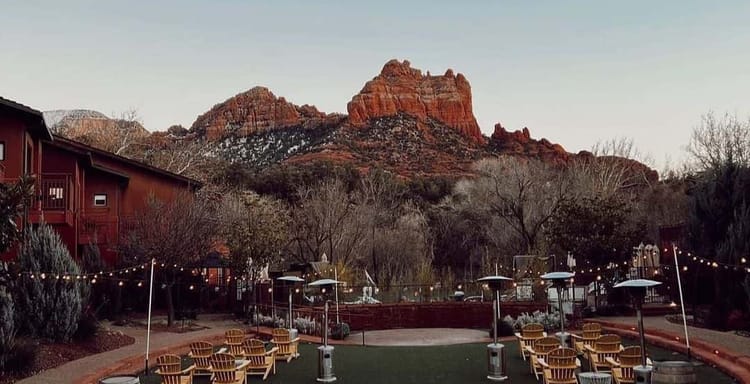 Red rock mountain with outdoor lounge and string lights, scenic view for travel and adventure.