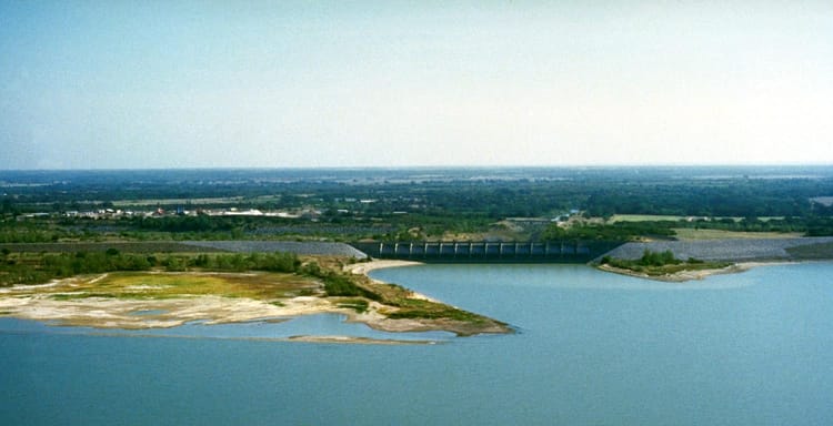 Dam and reservoir with water and surrounding landscape, flood control, water storage, QuestForDirections.