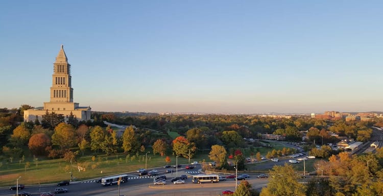 Historic Capitol Building in Austin Texas during golden hour, showcasing cityscape and lush greenery.