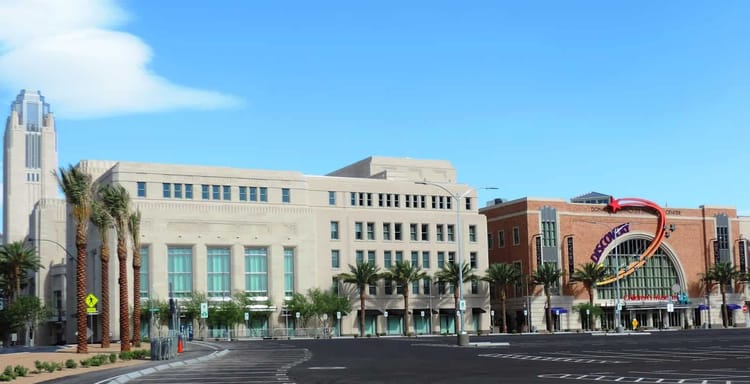 Modern urban building exterior with palm trees and clear blue sky at QuestForDirections.