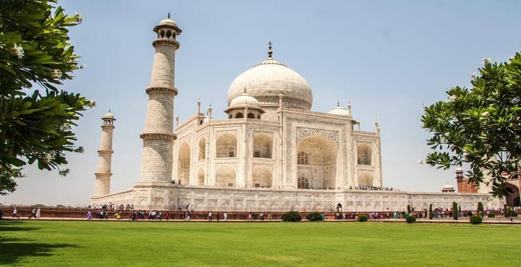 Magnificent Taj Mahal with lush gardens, iconic Indian heritage site, and tourism destination.