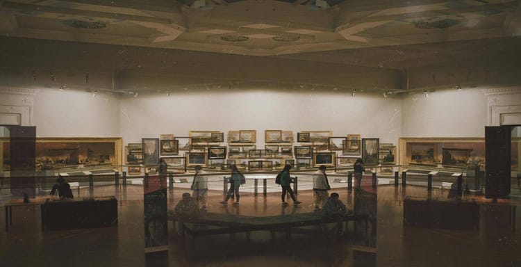 Old museum interior showcasing historical paintings and visitors exploring artwork.