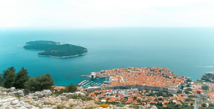 Historic coastal city with ancient walls and harbor, overlooking the Adriatic Sea in Croatia.