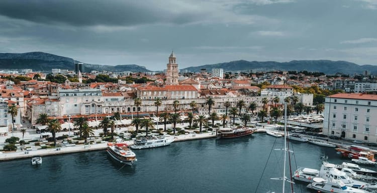 Colorful coastal cityscape of Dubrovnik with historic architecture and marina, perfect for travel planning and navigation.