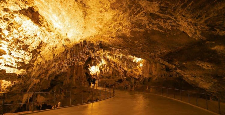 Stalactite cave tour at Quest For Directions, showcasing stunning underground rock formations.