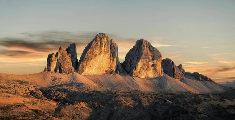 Majestic mountain landscape at sunrise, featuring rugged peaks and scenic terrain.