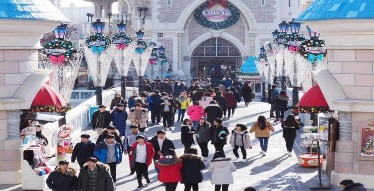 Vibrant holiday scene at QuestForDirections Christmas themed attraction, bustling crowd near festive castle entrance.