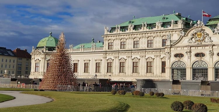 Colorful historic building with festive Christmas tree in Vienna, Austria.