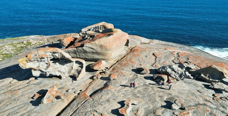 Stunning coastal rock formations with hikers enjoying scenic ocean views from Quest for Directions.