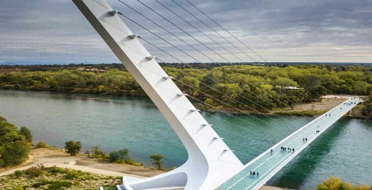 Modern suspension bridge over a river in Austin, Texas, showcasing innovative architecture and scenic views.