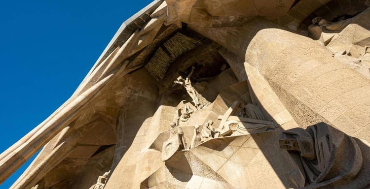 Intricate stone sculptures of religious figures on the Sagrada Familia basilica in Barcelona.