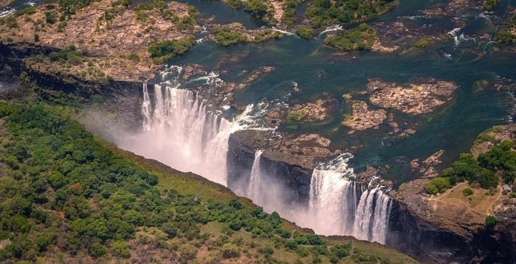 Breathtaking aerial view of Niagara Falls showcasing waterfalls and lush greenery.