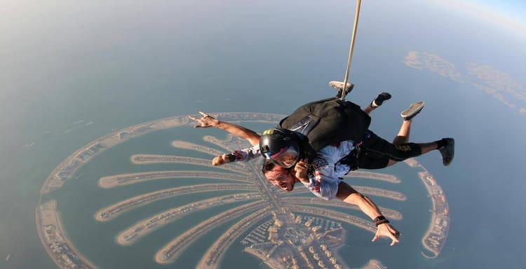Adrenaline-filled tandem skydiving over Dubai Palm Jumeirah with stunning city views.