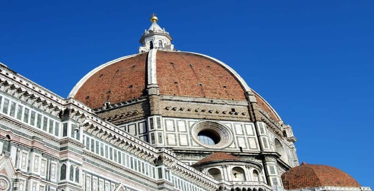 Majestic Florence Cathedral dome in Italy with intricate architecture and vibrant blue sky fill.