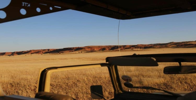 Stunning desert landscape viewed from a vehicle during a scenic road trip.