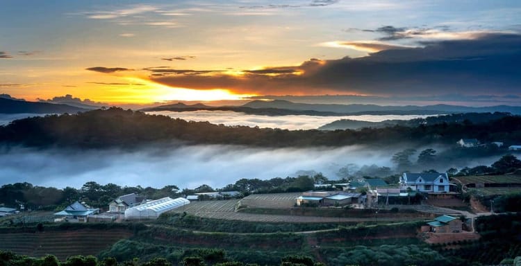 Vast scenic landscape with rolling hills, dawn sky, and mist-filled valleys in rural countryside.