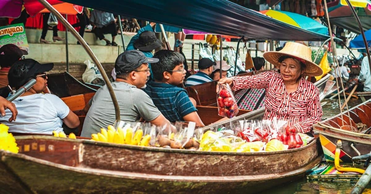 Vibrant floating market with fresh fruits and local vendors in Thailand.