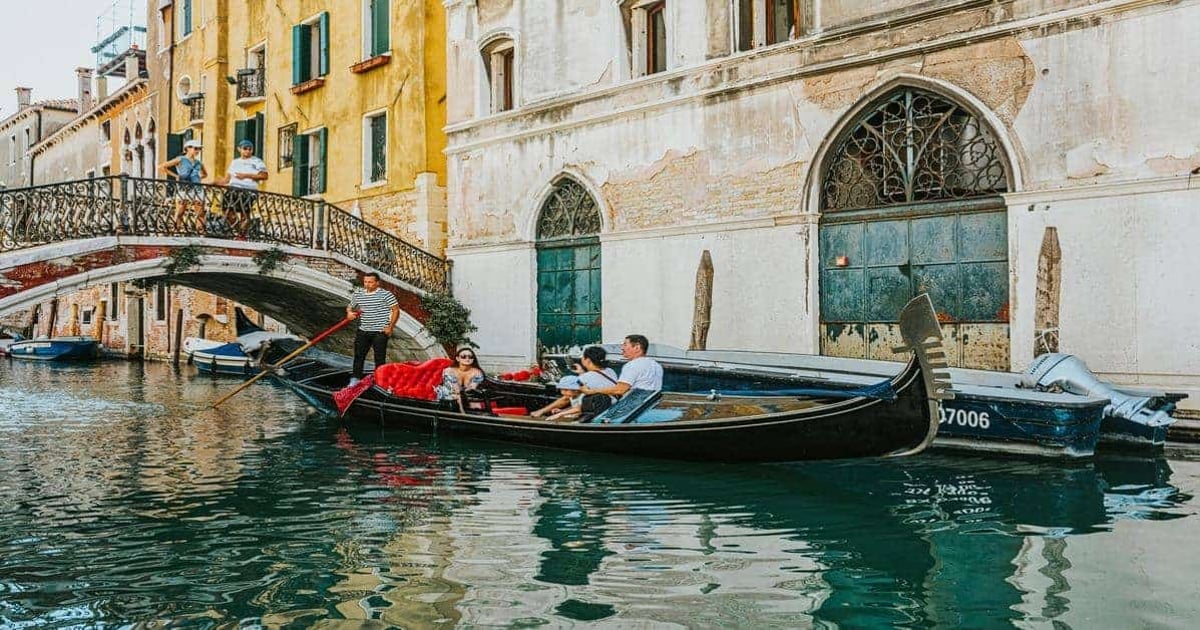 Venezian gondola ride along historic canals in Venice, Italy, with scenic architecture and picturesque views.