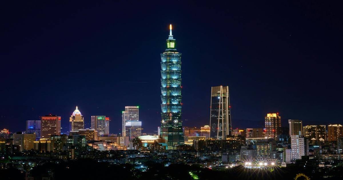 Bright Taipei 101 skyscraper illuminated at night in Taiwan, city skyline with vibrant lights.