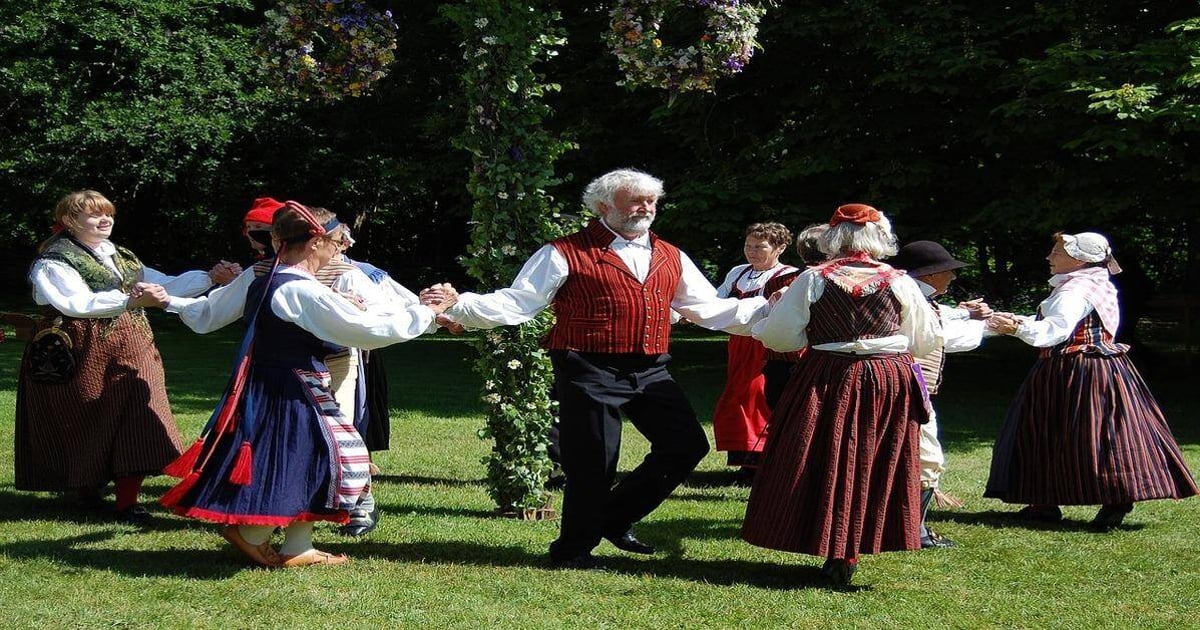 Traditional folk dance with people in historic costumes outdoors, showcasing cultural heritage.