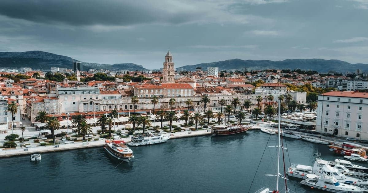 Colorful coastal cityscape of Dubrovnik with historic architecture and marina, perfect for travel planning and navigation.