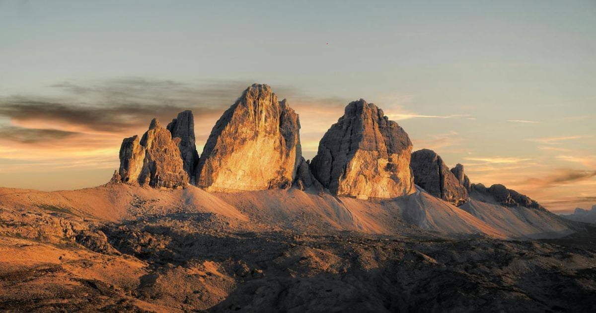 Majestic mountain landscape at sunrise, featuring rugged peaks and scenic terrain.