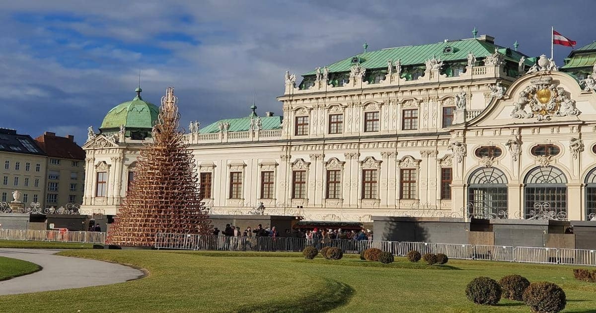 Colorful historic building with festive Christmas tree in Vienna, Austria.
