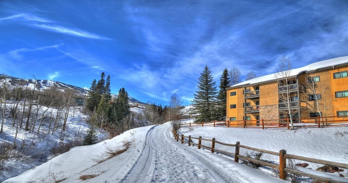 Snow-covered mountain road leading to Quest for Directions lodging in winter landscape.
