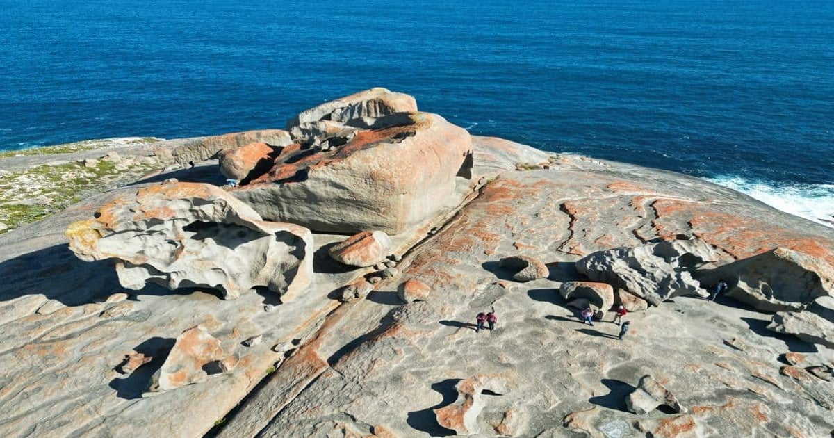 Stunning coastal rock formations with hikers enjoying scenic ocean views from Quest for Directions.
